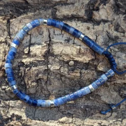 zoom sur un bracelet en sodalite posé sur une buche de bois