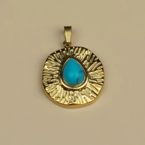 pendentif en turquoise et or sur fond